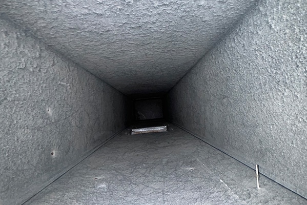 Supply trunk line being cleaned in a Bergen County, New Jersey home by J R Air Duct Cleaning